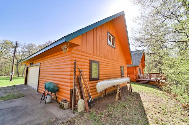24997 145th Ave, Fort Ripley, MN 56449 - view of property exterior with board and batten siding, a deck, a garage, asphalt driveway, and roof with shingles