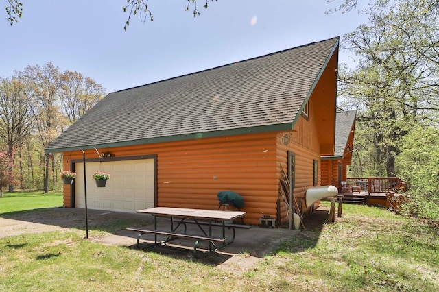 24997 145th Ave, Fort Ripley, MN 56449 - view of side of home featuring a shingled roof, a detached garage, a wooden deck, and a lawn