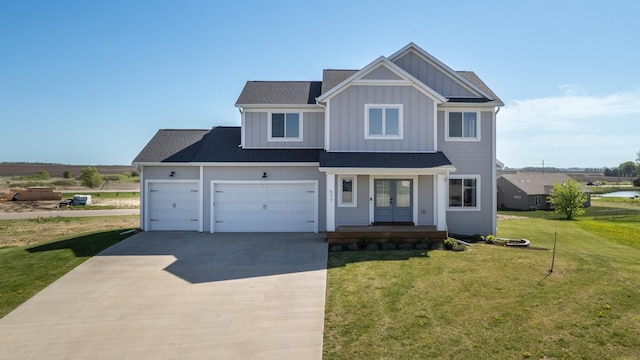 577 Keefe Ct NW, Eyota, MN 55934 - view of front of home with french doors, board and batten siding, concrete driveway, a front lawn, and a garage
