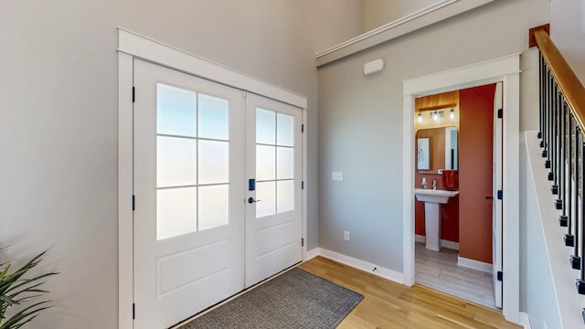 577 Keefe Ct NW, Eyota, MN 55934 - doorway to outside featuring stairs, light wood-type flooring, french doors, and baseboards