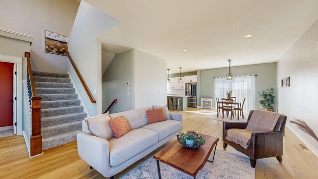 577 Keefe Ct NW, Eyota, MN 55934 - living room featuring light wood-type flooring, stairway, recessed lighting, and baseboards