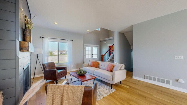 577 Keefe Ct NW, Eyota, MN 55934 - living area featuring baseboards, a large fireplace, light wood-style floors, stairs, and recessed lighting