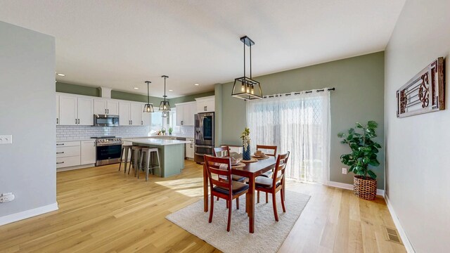 577 Keefe Ct NW, Eyota, MN 55934 - dining area with light wood-type flooring, baseboards, and recessed lighting