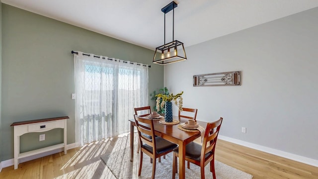 577 Keefe Ct NW, Eyota, MN 55934 - dining area with light wood-style flooring, a chandelier, and baseboards