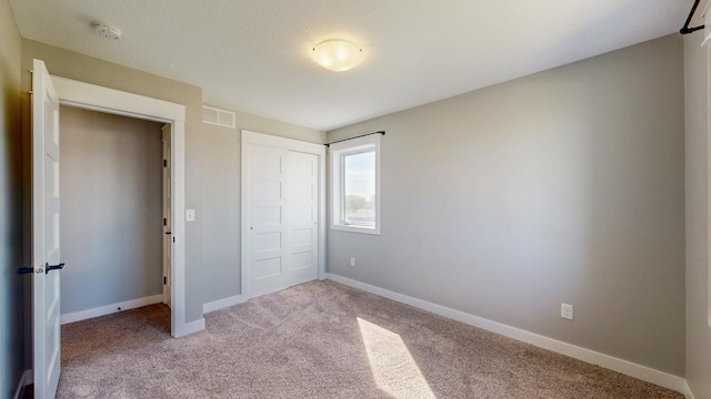 577 Keefe Ct NW, Eyota, MN 55934 - unfurnished bedroom with carpet, baseboards, and a closet