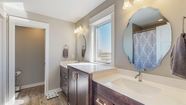 577 Keefe Ct NW, Eyota, MN 55934 - bathroom with vanity, baseboards, and wood finished floors