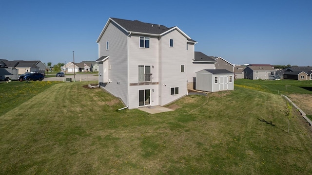 577 Keefe Ct NW, Eyota, MN 55934 - back of property featuring a residential view, a shed, an outdoor structure, and a lawn