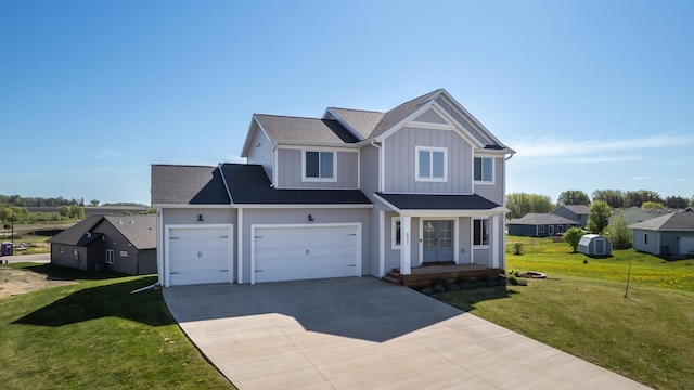 577 Keefe Ct NW, Eyota, MN 55934 - view of front facade with board and batten siding, concrete driveway, a front yard, and a porch
