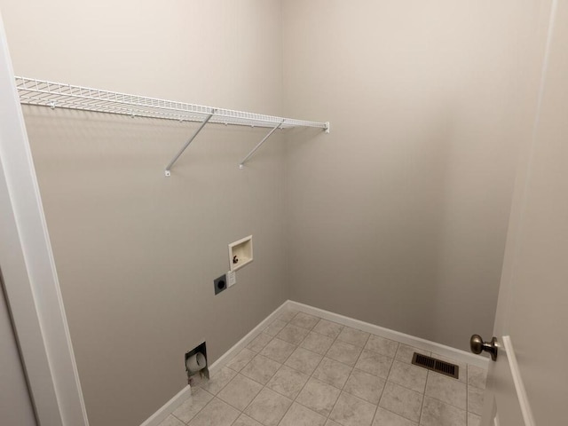 laundry area featuring hookup for an electric dryer, baseboards, washer hookup, and light tile patterned flooring