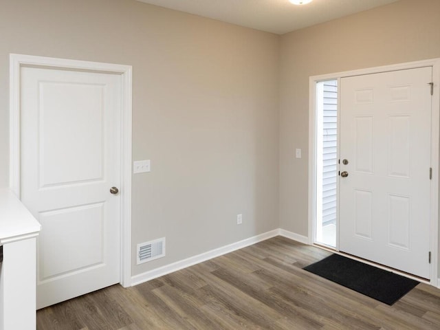 entrance foyer featuring wood finished floors and baseboards