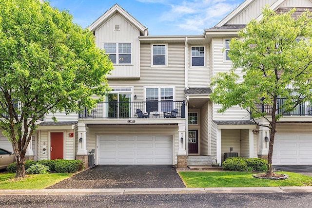 11852 Emery Village Dr N Unit 3302, Champlin, MN 55316 - multi unit property with board and batten siding, a balcony, an attached garage, driveway, and cooling unit