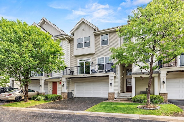 11852 Emery Village Dr N Unit 3302, Champlin, MN 55316 - multi unit property featuring board and batten siding, a balcony, an attached garage, central AC, and driveway