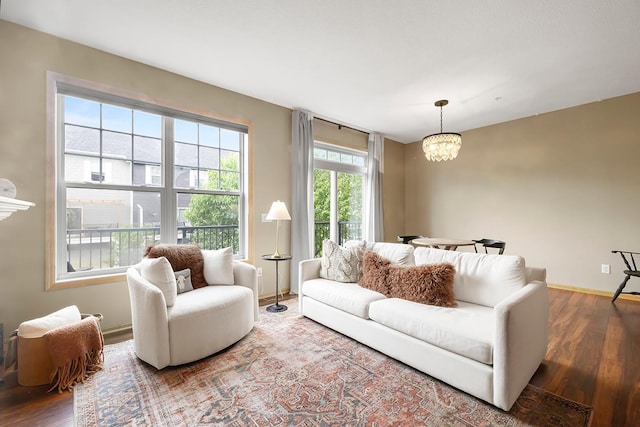 11852 Emery Village Dr N Unit 3302, Champlin, MN 55316 - living room featuring wood finished floors, a chandelier, and baseboards