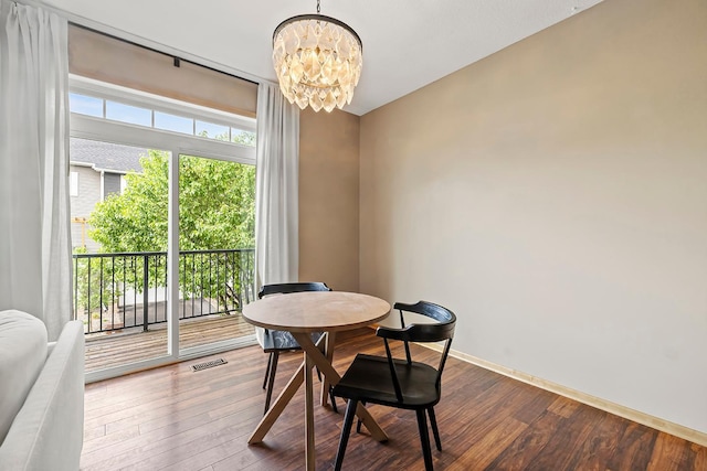 11852 Emery Village Dr N Unit 3302, Champlin, MN 55316 - dining room with a chandelier, dark wood finished floors, and baseboards