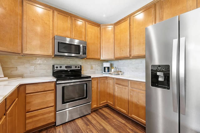 11852 Emery Village Dr N Unit 3302, Champlin, MN 55316 - kitchen featuring appliances with stainless steel finishes, dark wood-style floors, light countertops, and decorative backsplash