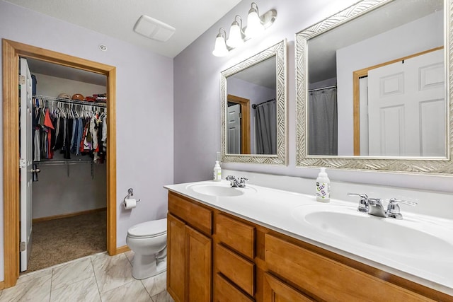11852 Emery Village Dr N Unit 3302, Champlin, MN 55316 - bathroom featuring double vanity, toilet, a spacious closet, and marble finish flooring