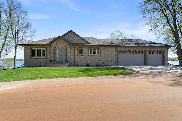 46463 Cambridge Dr, Stanchfield, MN 55080 - view of front of home featuring driveway, an attached garage, brick siding, and a front yard