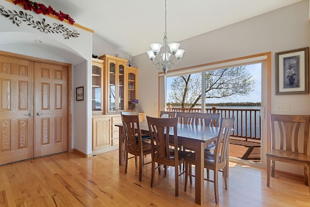 46463 Cambridge Dr, Stanchfield, MN 55080 - dining space featuring a chandelier, light wood-style floors, a water view, and baseboards