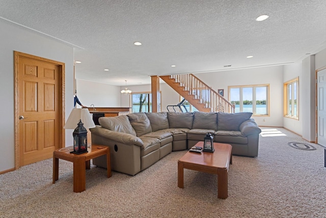 46463 Cambridge Dr, Stanchfield, MN 55080 - living room featuring light colored carpet, a textured ceiling, stairs, a chandelier, and recessed lighting