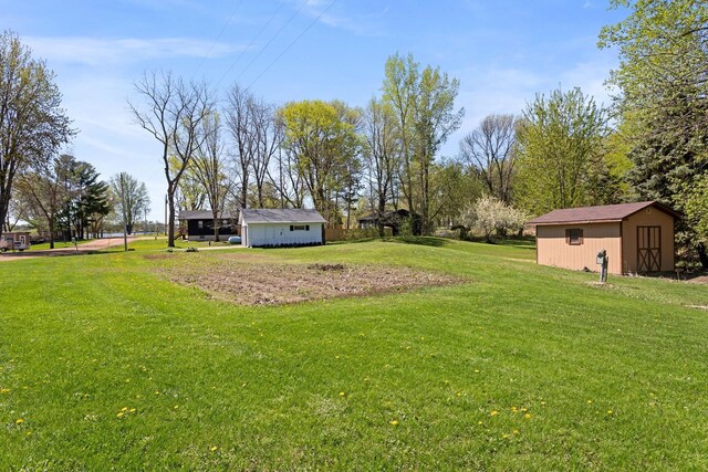 46463 Cambridge Dr, Stanchfield, MN 55080 - view of green lawn featuring an outbuilding and a shed