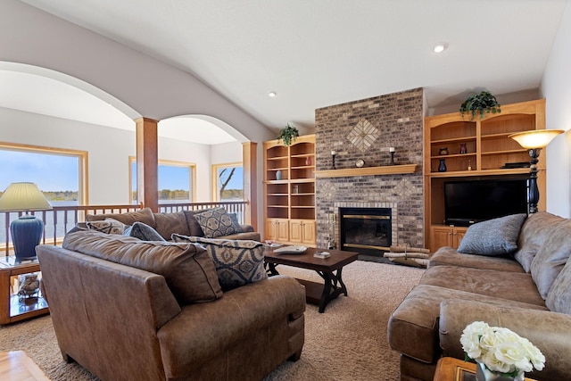 46463 Cambridge Dr, Stanchfield, MN 55080 - living area with healthy amount of natural light, arched walkways, vaulted ceiling, a brick fireplace, and recessed lighting