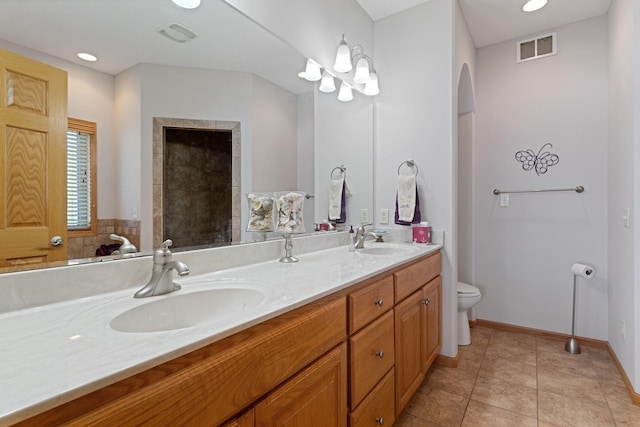 46463 Cambridge Dr, Stanchfield, MN 55080 - full bathroom with double vanity, toilet, tile patterned flooring, and baseboards