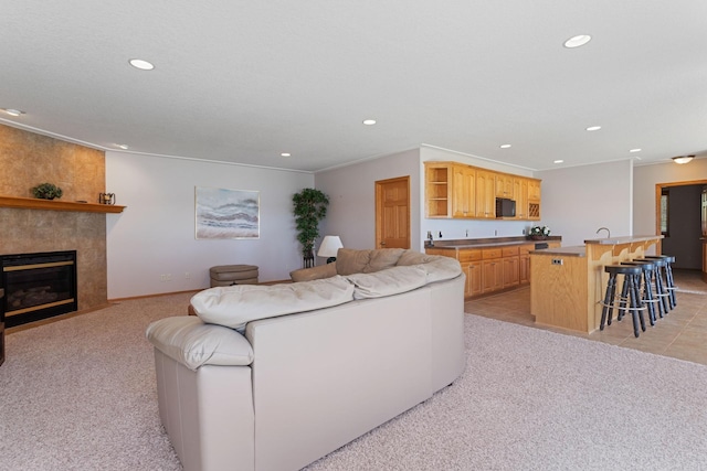 46463 Cambridge Dr, Stanchfield, MN 55080 - living area with recessed lighting, light carpet, a tiled fireplace, and baseboards