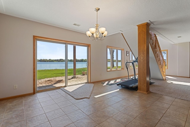 46463 Cambridge Dr, Stanchfield, MN 55080 - workout area with a water view, a chandelier, baseboards, and tile patterned flooring