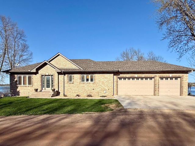 46463 Cambridge Dr, Stanchfield, MN 55080 - ranch-style home with concrete driveway, an attached garage, brick siding, and a front yard