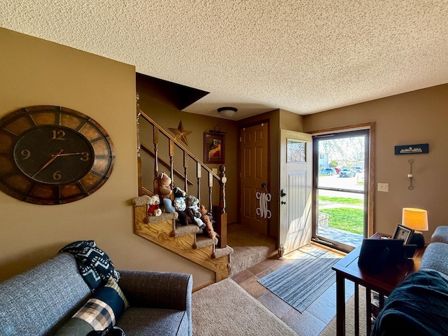living room with a textured ceiling and stairway