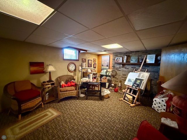interior space featuring a paneled ceiling and carpet floors