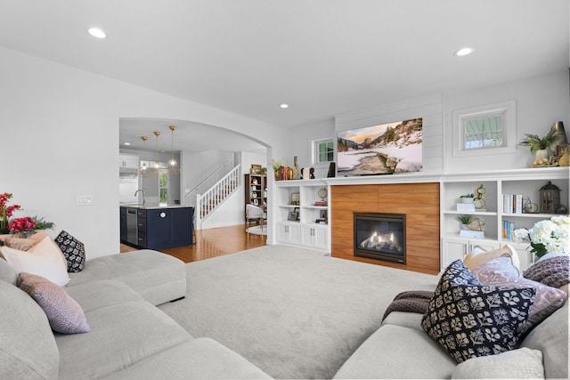 11464 Wagon Wheel Curv, Woodbury, MN 55129 - living room with arched walkways, wood finished floors, recessed lighting, stairs, and a fireplace with flush hearth