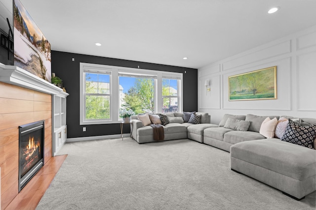 11464 Wagon Wheel Curv, Woodbury, MN 55129 - living area featuring a tile fireplace, a decorative wall, and recessed lighting