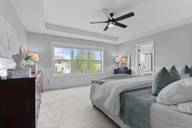 11464 Wagon Wheel Curv, Woodbury, MN 55129 - bedroom featuring a tray ceiling, carpet floors, wainscoting, and ceiling fan