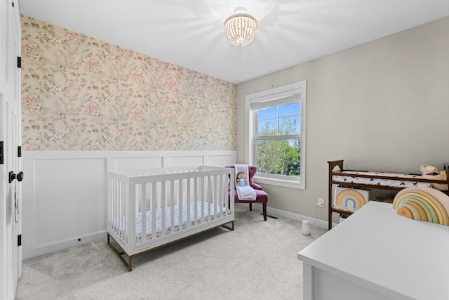 11464 Wagon Wheel Curv, Woodbury, MN 55129 - bedroom with a chandelier, light colored carpet, wallpapered walls, a crib, and a wainscoted wall