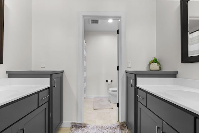 11464 Wagon Wheel Curv, Woodbury, MN 55129 - full bathroom featuring two vanities, toilet, baseboards, and tile patterned floors