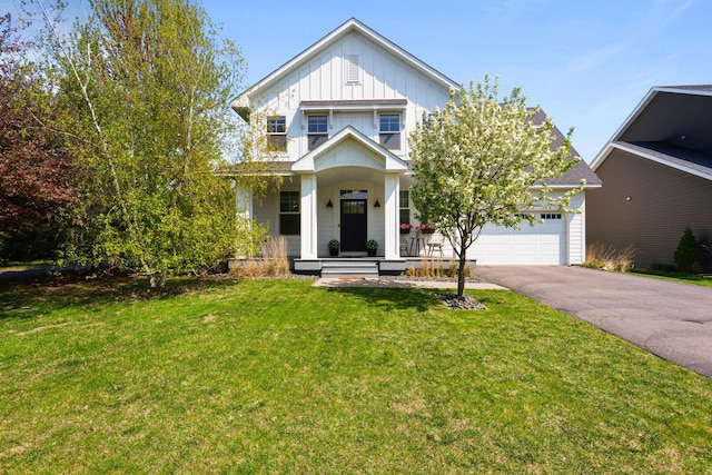 11464 Wagon Wheel Curv, Woodbury, MN 55129 - view of front of property featuring a porch, board and batten siding, driveway, a front yard, and a garage