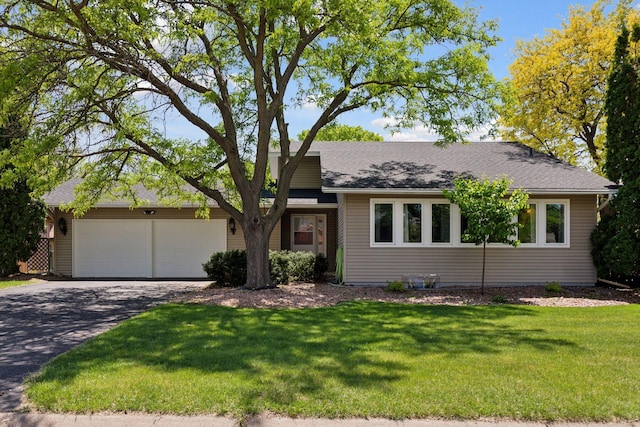7900 Idaho Cir N, Brooklyn Park, MN 55445 - view of front facade with an attached garage, driveway, and a front lawn