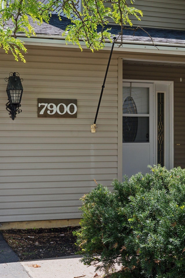 7900 Idaho Cir N, Brooklyn Park, MN 55445 - view of property exterior with a shingled roof