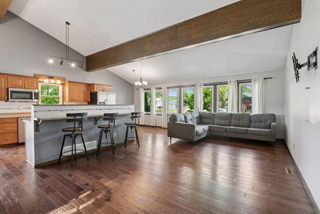 7900 Idaho Cir N, Brooklyn Park, MN 55445 - living room featuring a chandelier, dark wood-style flooring, high vaulted ceiling, and beam ceiling
