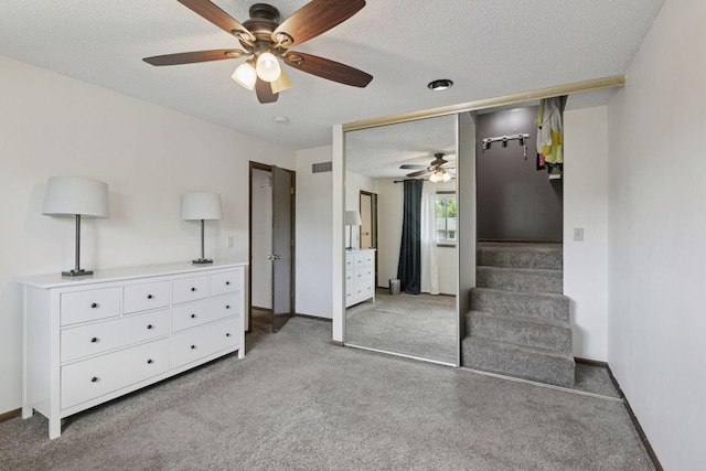 7900 Idaho Cir N, Brooklyn Park, MN 55445 - bedroom with light carpet, baseboards, a closet, ceiling fan, and a textured ceiling
