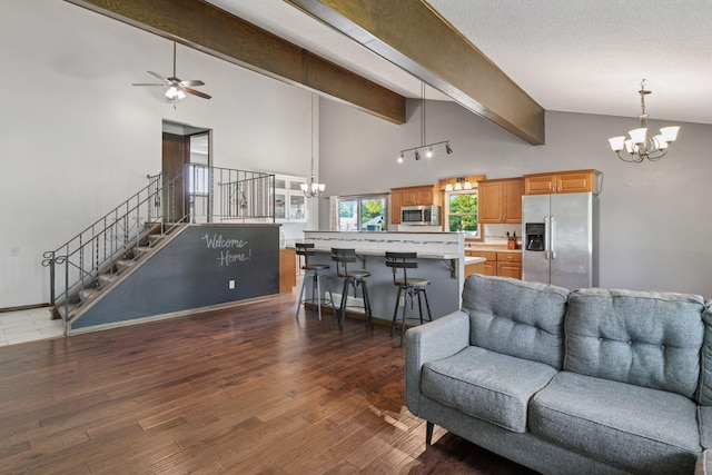 7900 Idaho Cir N, Brooklyn Park, MN 55445 - living room with a chandelier, beamed ceiling, wood finished floors, high vaulted ceiling, and a ceiling fan