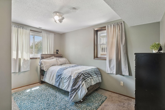 7900 Idaho Cir N, Brooklyn Park, MN 55445 - bedroom with carpet floors, baseboards, and a textured ceiling