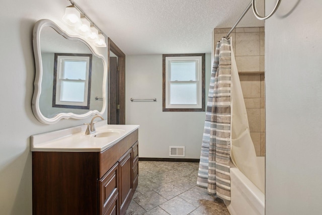 7900 Idaho Cir N, Brooklyn Park, MN 55445 - bathroom featuring vanity, a textured ceiling, shower / tub combo, and baseboards