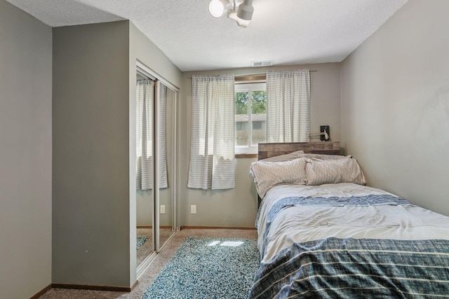 7900 Idaho Cir N, Brooklyn Park, MN 55445 - carpeted bedroom featuring a textured ceiling, baseboards, and a closet