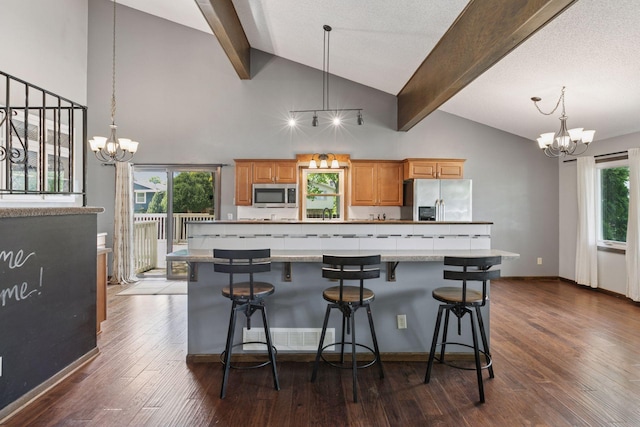 7900 Idaho Cir N, Brooklyn Park, MN 55445 - kitchen featuring appliances with stainless steel finishes, a chandelier, beam ceiling, a kitchen breakfast bar, and dark wood-style flooring