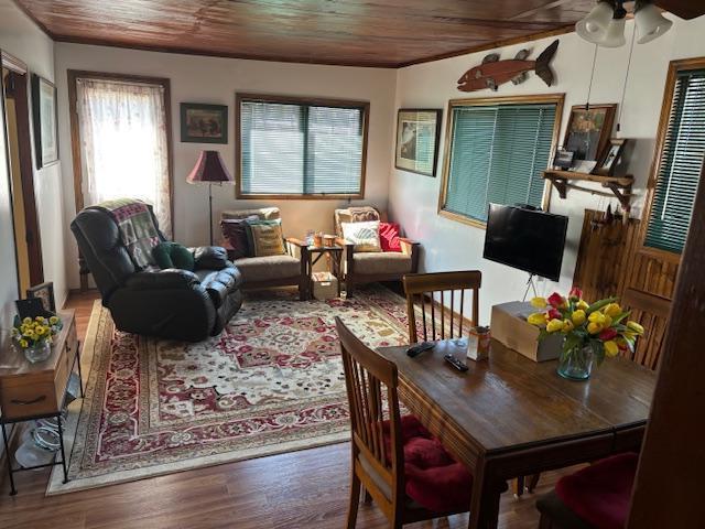 interior space with wood ceiling, wood finished floors, and ceiling fan