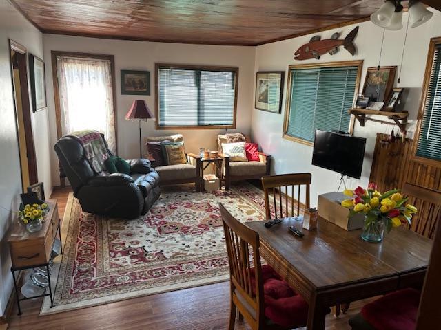 living area featuring ceiling fan, wood ceiling, and wood finished floors