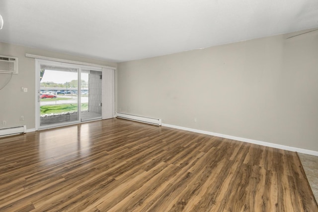 unfurnished room featuring a baseboard radiator, wood finished floors, and baseboards