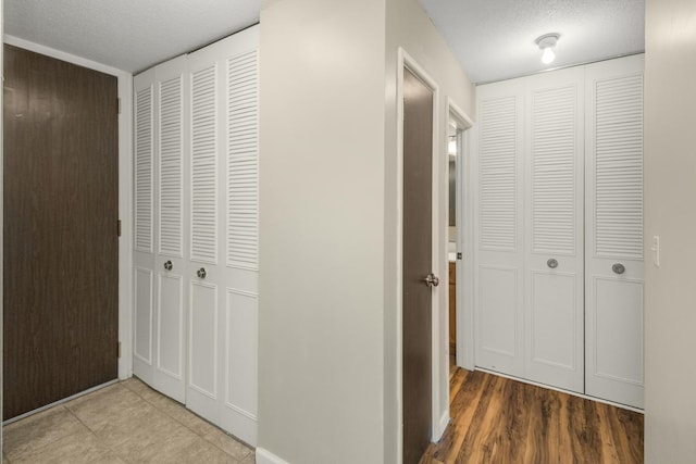 hallway with a textured ceiling